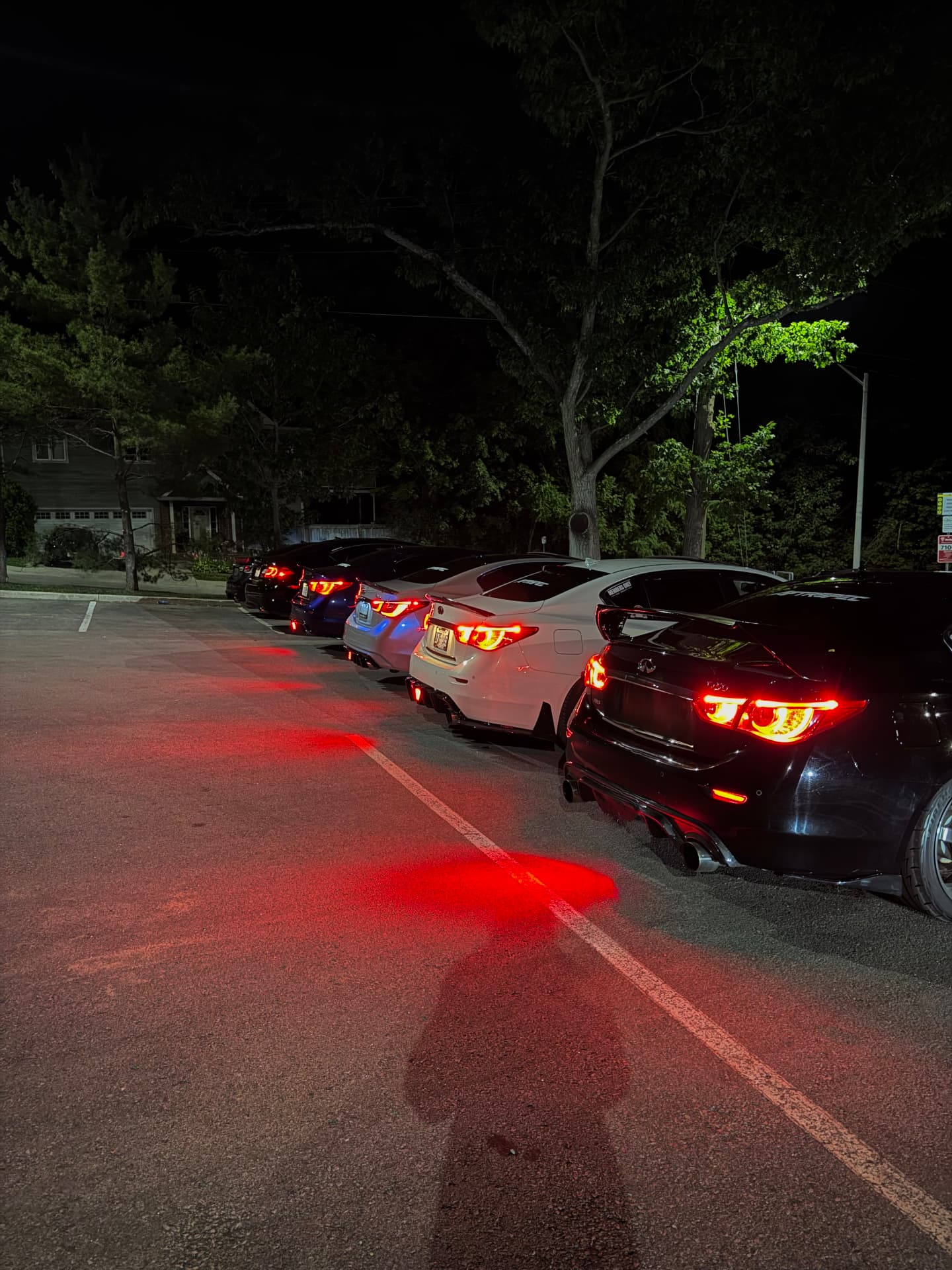 Line of AFTRSPEC-repped builds at a night meet
